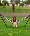 Double Hammock With Steel Stand Included 450Lb Capacity Portable Backyard Camping Garden Hammock With Premium Carry Bag And Anti Roll Balance Beams In Brown Stripes For Ultimate Outdoor Vibes installed on grass