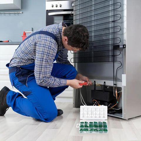 Technician repairing fridge with 270 Pcs O Ring Kit With 18 Size Assortment High Temperature Buna N Rubber Gaskets nearby on floor.