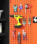 Heavy Duty Steel Tool Cabinet With Secure Lock Drawer And Multiple Shelves For Garage Workshop Organization filled with tools on an orange pegboard.