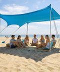 Group under Big 14x11 Foot Beach Shade Shelter With UPF50 Protection, Easy Setup Canopy on sandy beach, ocean background