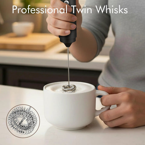 Usb Rechargeable Milk Frother Handheld 2 In 1 Dual Spring Whisk Electric Frother Wand creating foam in a white mug on a kitchen counter