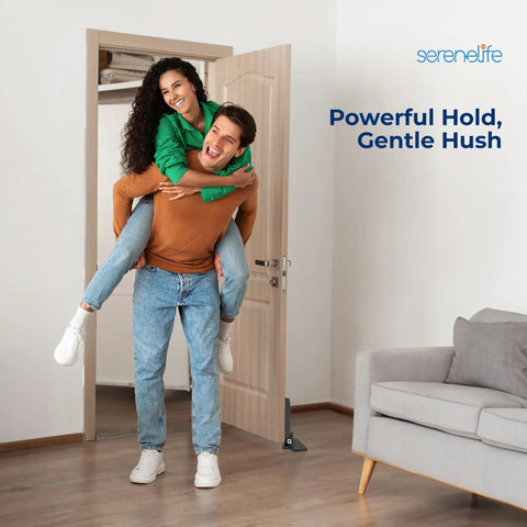 Heavy Duty Carbon Steel Door Stopper Features Hydraulic Soft Close For Smooth Operator Swing Tough As Nails Wall Guard For Hallways And Offices No Drama Bolt Down Setup Hangs Steady Through Thick And Thin Matte Black in home setting with couple.