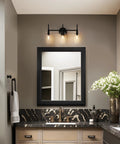 Black 3-light vanity over mirror in bathroom