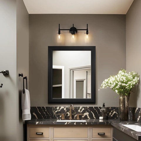 Black 3-light vanity over mirror in bathroom