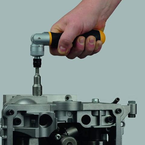 Hand using Ergonic K II 20 Piece Ratchet Set With 180 Degree Pivoting Handle And One Quarter Inch Quick Release Bit Holder, 60 Tooth Ratcheting on engine part