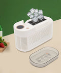 Fast Freeze Mini Countertop Ice Maker with clear lid, producing crisp white ice cubes, compact design for home bars.