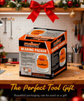 Box of Premium Wheel Bearing Packer Tool Kit With Self Contained Piston on workshop table with festive decorations.