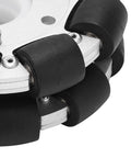 Close-up of a 100mm aluminum omni wheel with rubber rollers on a metal housing
