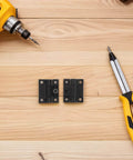 Adjustable Plastic Cabinet Door Hinges Set 90 Degree Torque Friction Positioning Black Foldable Pair on wooden surface