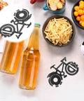 Bike Shaped Multitool Keychain Portable Stainless Steel Cyclist Gear beside snacks and bottles on a table