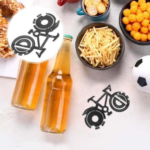 Bike Shaped Multitool Keychain Portable Stainless Steel Cyclist Gear beside snacks and bottles on a table