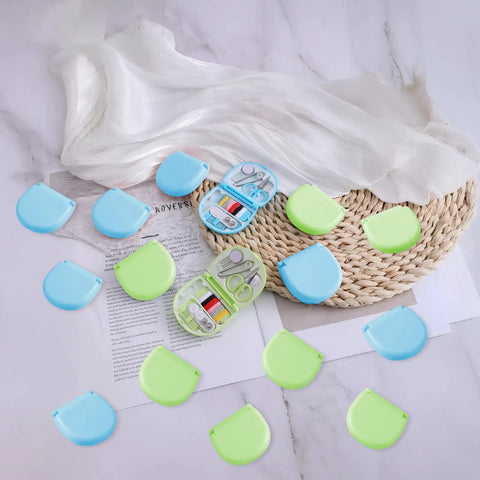 20 Pack Mini Travel Sewing Kit Set For On The Go Repairs With Scissors Needles Thread Spools And Emergency Fix Essentials In Durable Blue And Green Case shown open on a wicker surface