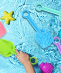 24 Pack Beach Shovels For Kids, 7 Point 7 Inch Plastic Sand Scoops In Bright 5 Colors floating in water with child's hand grabbing a green scoop