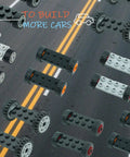 Wheels And Axles Set For City Cars And Trucks 118 Piece Building Block Parts Kit with assembled axles on a road background