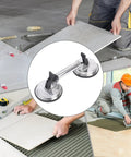 Heavy Duty Glass Suction Cup With Stainless Steel Handle For Lifting Heavy Tiles, shown lifting a tile securely during installation.