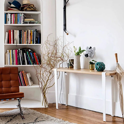 Four Piece Beefy Metal Table Legs Adjustable F Shape Desk Base With Non Slip Rubber Feet supporting a wooden tabletop in a stylish room.
