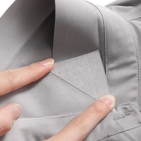 240 Pack Invisible Adhesive Shirt Collar Stays being placed inside a gray shirt collar for a crisp look.