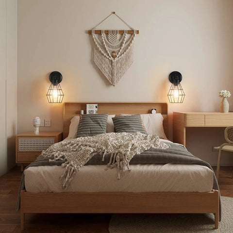 Industrial Wire Cage Wall Sconce Two Pack Vintage Farmhouse Lighting illuminating bedroom headboard with cozy vibe