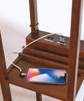 Charging area of Maxwell Charger Shelf Floor Lamp with USB Ports and Electrical Outlet in Havana Brown with smartphone charging.