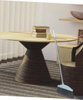Grime Crushing Heavy Duty Broom With 34 Inch Long Handle For Sweeping Concrete Driveway Garage Patio And Indoor Floors No Sweat Household Cleaner With Convenient Storage Hook propped against a chair in a modern room.