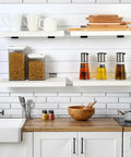 4 Pack Wooden Slatwall Shelves With 8 Metal Hooks Built To Last And Garage Ready For Quick Setup In Your Home Or Workshop With 16.1 Inch Deep 6.7 Inch Wide And 1.1 Inch High Slatwall Organizer Set For Garage And Workbench Storage installed in kitchen with utensils displayed.