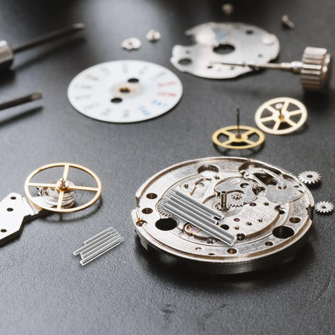Watch Band Pins Repair Kit Set With Durable Spring Bar Pins displayed on a watch movement during repair.