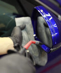Using Pro Air Pressure Blow Gun With Beast Mode Jet Nozzle 230 Max PSI for car detailing on blue side mirror.