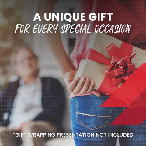 A person holding a gift box with a red bow for special occasions, featuring a blurred background of another person.