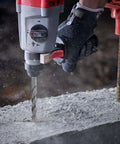 Close-up: rotary hammer drill with an SDS-Plus masonry bit drilling into concrete; 4-piece set 6/8/10/12 mm