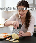 Front view of French fry slicer with large crinkle cutter, black handle, stainless steel blade slicing potatoes.