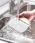 Rpanle vegetable crinkle cutter with wooden handle and stainless steel blade, close-up in sink under running water