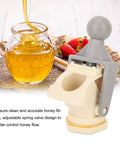Ergonomic Honey Gate Valve with Ball Handle next to a jar of honey, demonstrating easy drain and precise fill for beekeeping.
