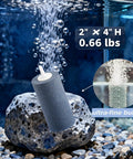 Six Pack Large 4 By 2 Inch Round Air Stones For Aquarium And Hydroponics in a tank, on rocks, releasing bubbles.