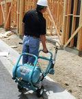 No Nonsense 3.0 HP Big Bore Air Compressor being wheeled at a construction site with wooden framing.