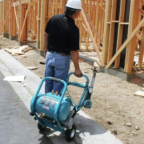 No Nonsense 3.0 HP Big Bore Air Compressor being wheeled at a construction site with wooden framing.
