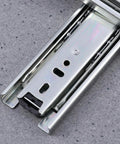 Rock Solid Steel Ball Bearing Drawer Slide Silent Telescopic Rail with Slick Glide Action, close-up view of heavy-duty steel section.