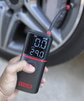 Slick Rechargeable Tire Inflator And Portable Air Compressor Featuring Digital Led Display and Automatic Shutoff in hand.