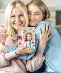 Two women holding a decorated frame from DIY Wooden Picture Frame Craft Kit With 24 Blank Frames, Paint Set With 12 Colors And 2 Brushes