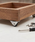 Eight Pack Of One Half Inch Rigid Caster Wheels With Compact Low Profile Design For Smooth Rolling On Desks And Furniture Includes Premium Hardware Pieces on wooden cart.