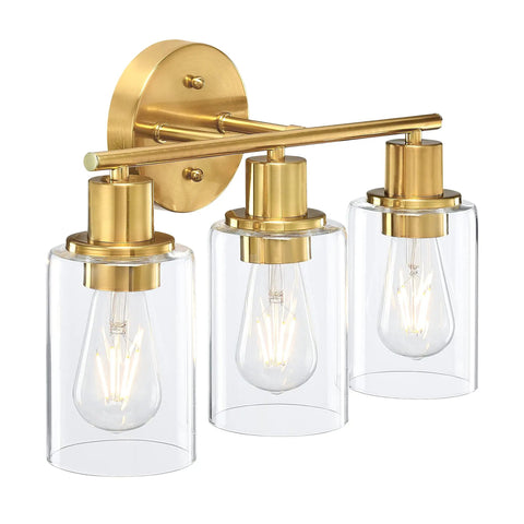Brass vanity light with three clear glass shades, adjustable up or down mount, modern wall sconce over mirror fixture delivering bright illumination.