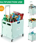 Front view of mint-green foldable utility cart with four wheels and extendable handle filled with groceries