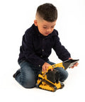Child playing with Cat Compact Track Loader Toy with Adjustable Lockable Loading Arm and Moveable Rubber Tracks indoors