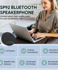 Woman using laptop with SP92 Plug And Play Conference Speaker And Microphone With AI Noise Cancellation beside her.