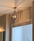 Open Globe Chandelier 21 Inch 4-Light Modern Sphere Orb Pendant in Brushed Nickel Finish hanging in a room
