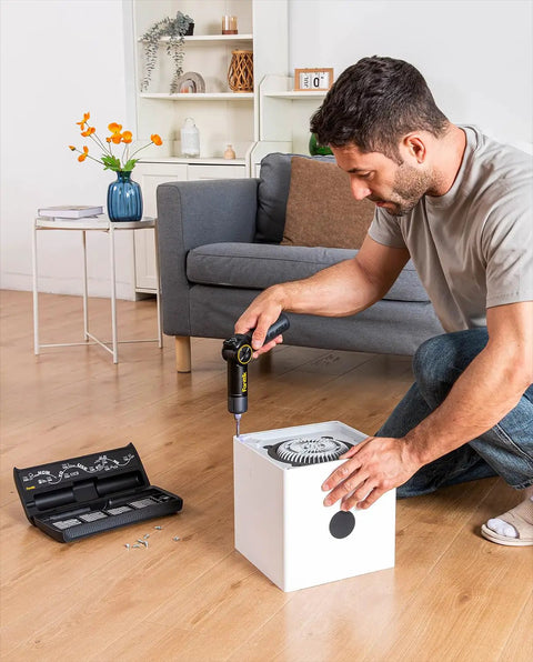 Man using Top Shelf Electric Screwdriver With Pivoting Handle And Crisp Digital Torque Display Featuring Eight Precise Settings For Laptop Repair And Diy Tasks That Deliver Knockout Precision Every Time to assemble a device.