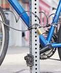Bicycle secured with Beefy Heavy Duty Flexible Steel Loop Cable With Vinyl Coated Wrap For Corrosion Protection Six Feet Long Quarter Inch Diameter Gray Finish 1500 Pound Break Strength Great For Securing Gear And Equipment on a metal post.