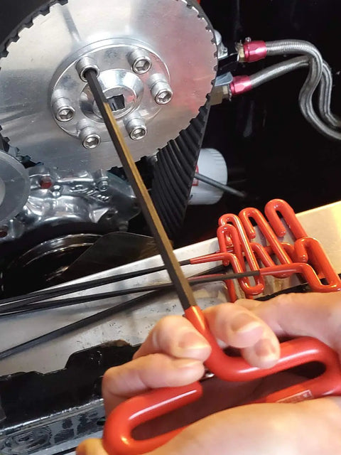 Person using 14 Piece Cushion Grip Hex T Key Set Inch And Metric Allen Wrenches 9 Inch Arm Made In USA on metallic part