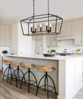 Farmhouse Five Light Candle Pendant Chandelier in Matte Black over kitchen island, industrial rustic ceiling light fixture