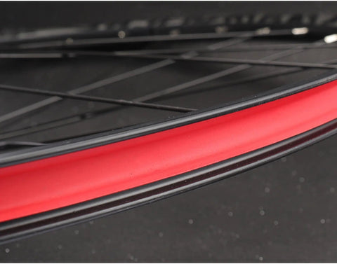 Close-up of heavy duty bike rim liner tape for tubes and rims, tough as nails puncture protection, red rim tape on a wheel.