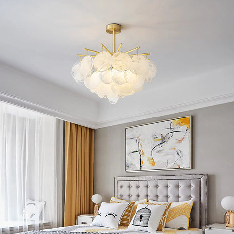 Showstopper Modern Luxury Crystal Rain Drop Chandelier Pendant Light Fixture in elegant bedroom setting with art and cushions